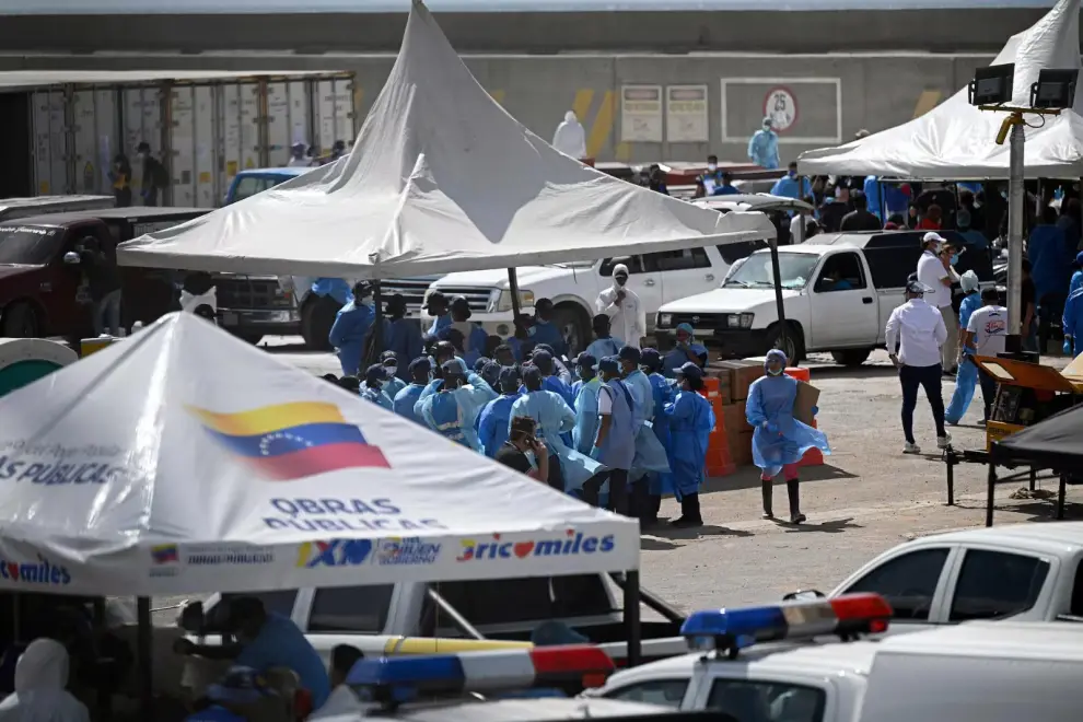 Personal forense trabaja bajo carpas durante las tareas de identificación de cuerpos en una morgue improvisada en el puerto de La Guaira, Venezuela. 
